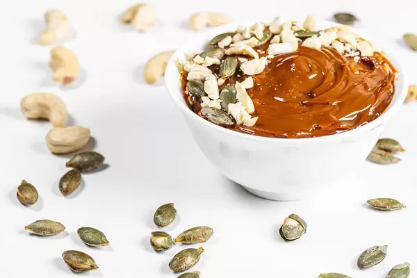 Dessert with condensed milk, cashew nuts and pumpkin seeds