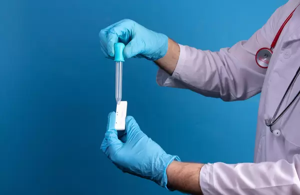 Detail for test in hands medical assistent during dripping swab sample for Covid-19 rapid antigen test