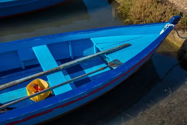 Detail of boat, fisherman harpoon and empty beer can