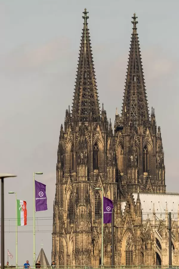 Deutz Suspension Bridge with Gamescom flags and Cologne Cathedral in the background