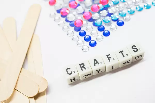 Dice reading CRAFTS with popsicle sticks and diamond stickers