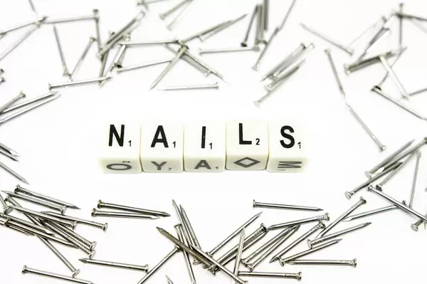 Dice reading NAILS with nails around