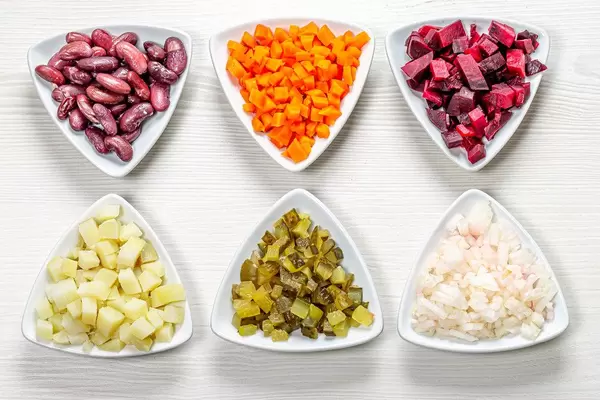 Diced vegetables in triangular plates. Top view (Flip 2019)