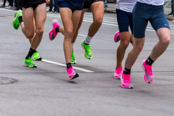 Die Beine von mehreren Marathonläufern in Nike ZoomX Vaporfly Next% Laufschuhen beim Chicago Marathon 2019