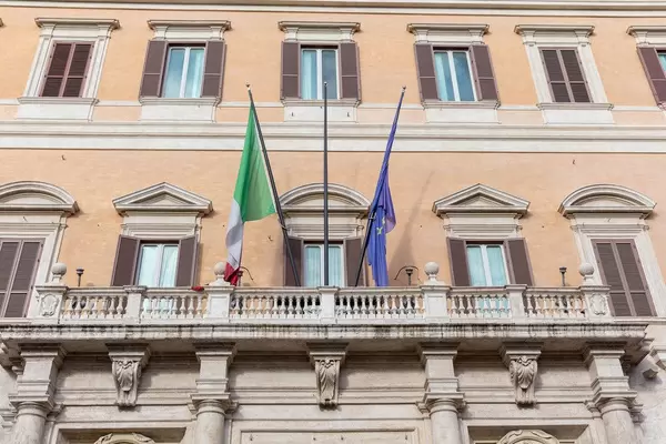 Die Italienische und die Europäische Fahne an einem Gebäude auf einem Platz in Rom