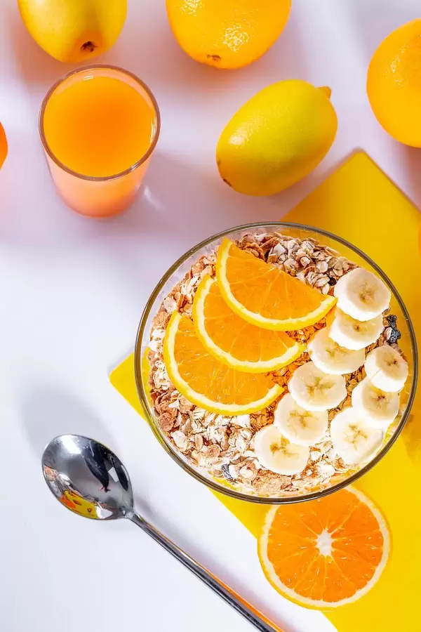 Diet breakfast with porridge and fruit orange, lemon and banana with a glass of fresh juice