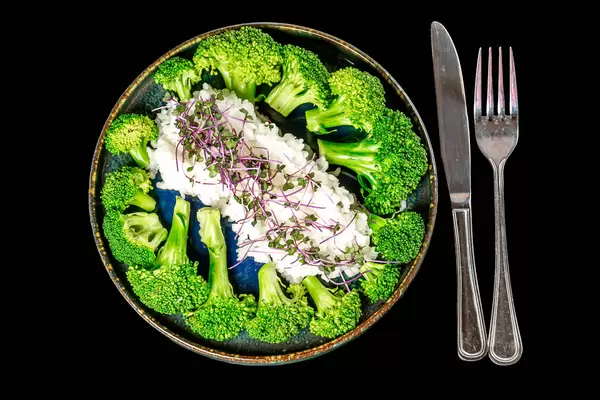 Diet lunch with rice, broccoli and microgreens, top view