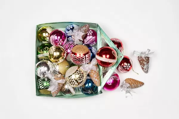 Different christmas ornaments in a box, on a white background