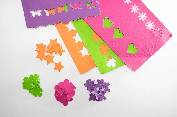 Different color paper cut outs on a white background (Flip 2019)