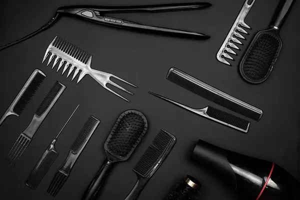 Different hair styling tools on black