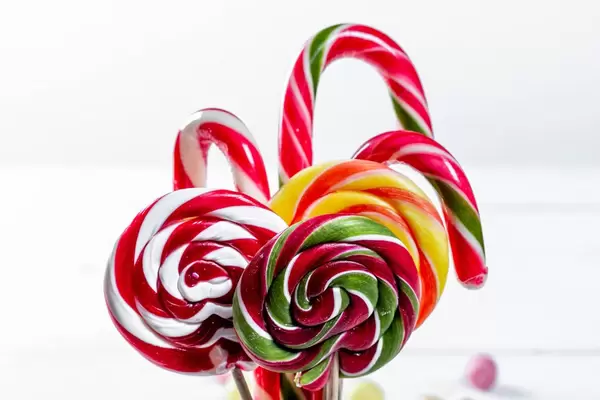 Different tasty colorful candies on white background
