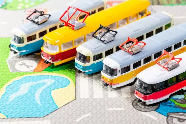 Different toy trams on the carpet to learn the rules of the road