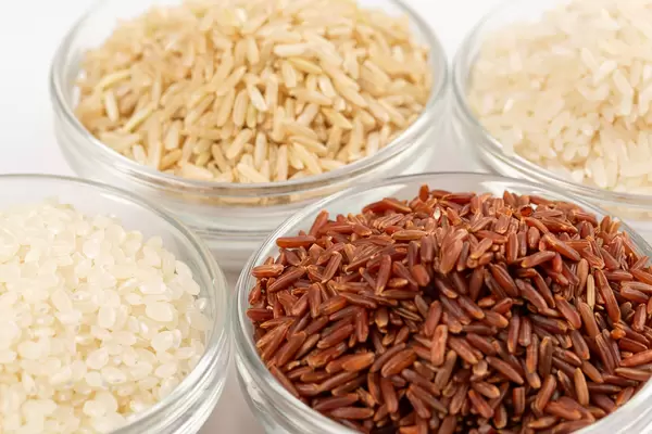 Different varieties of rice in glass bowls