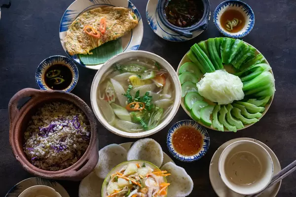 Different Vietnamese Dishes on a Wooden Table in a Restaurant in Ho Chi Minh City, Vietnam
