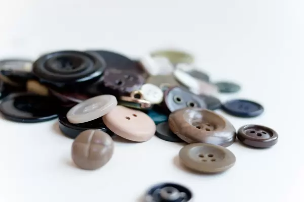 Differently formed and coloured buttons on a white background