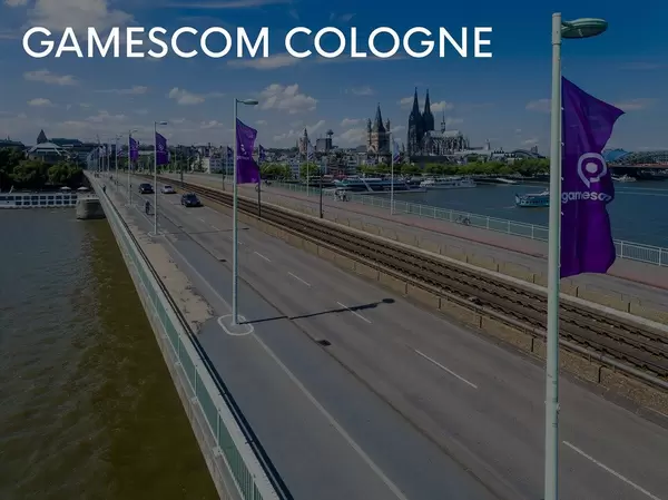 Direction to Gamescom in Cologne is accompanied by flags of the games fair, with the cathedral in the background