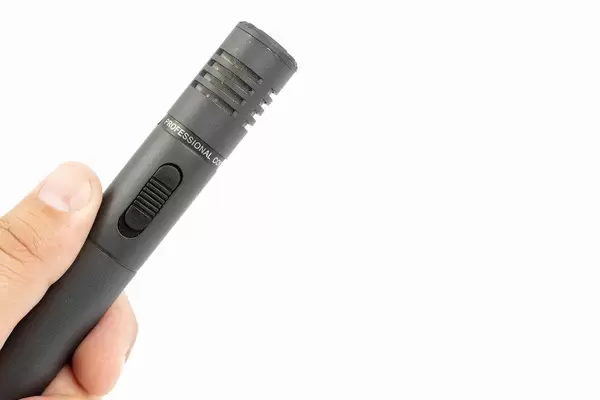 Directional Condenser Microphone in the hand above white background