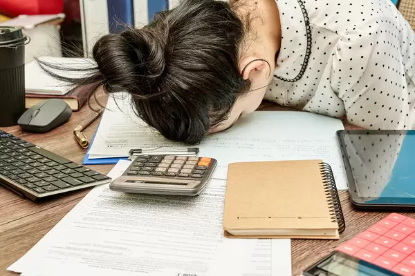 Disappointed and tired woman laid her head down on the table