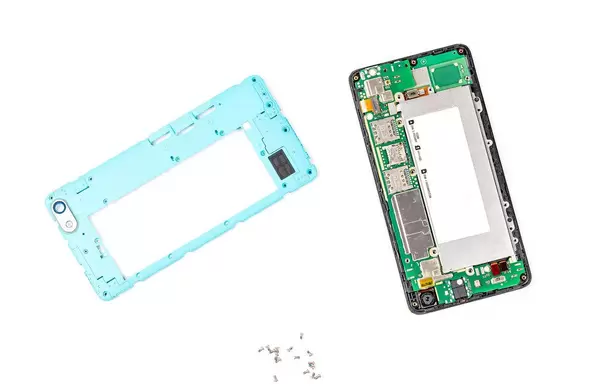 Disassembled smartphone with cover and screws on a white background (Flip 2020)