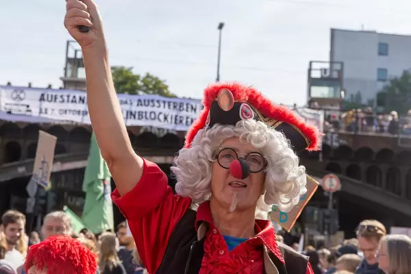 Disguised demonstrator loudly participates at Fridays for Future on Cologne's streets