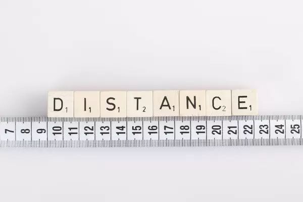 Distance text on wooden blocks with white tape measure