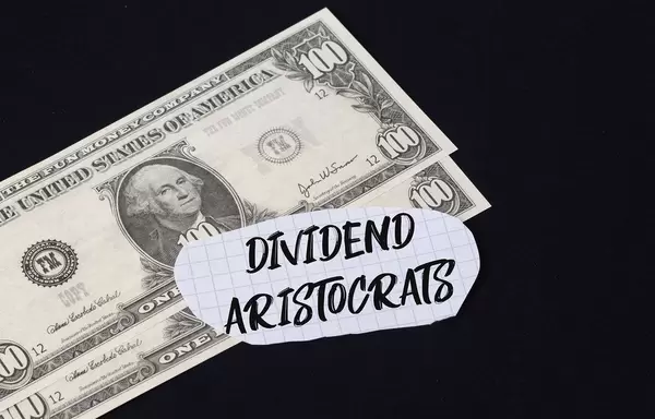 Dividend Aristocrats text and dollar banknotes