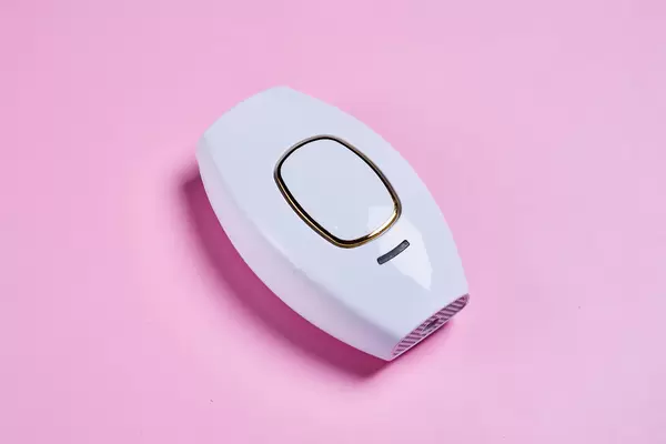 DIY laser hair removal handset on pink background