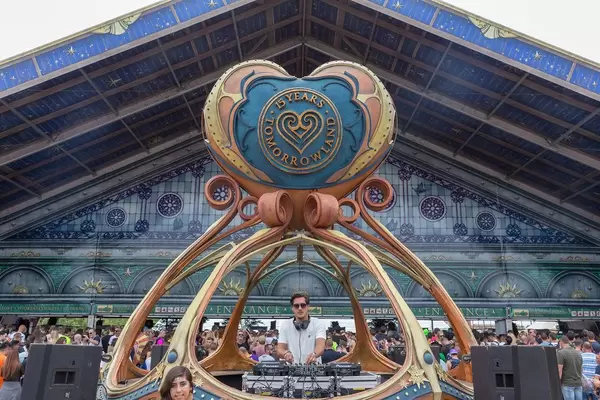 DJ plays music while people are waiting to get in to Tomorrowland festival in Boom, Belgium