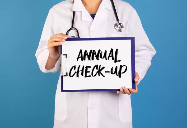 Doctor holding clipboard with Annual Check-up text