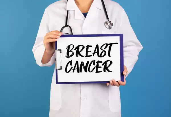Doctor holding clipboard with Breast cancer text