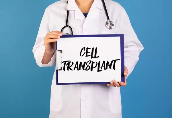 Doctor holding clipboard with Cell transplant text