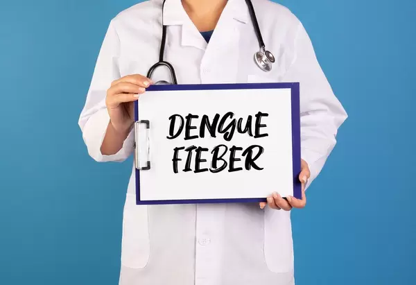Doctor holding clipboard with Dengue Fieber text