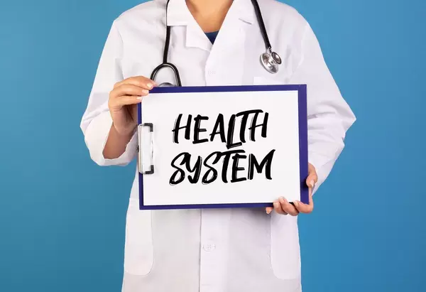 Doctor holding clipboard with Health system text