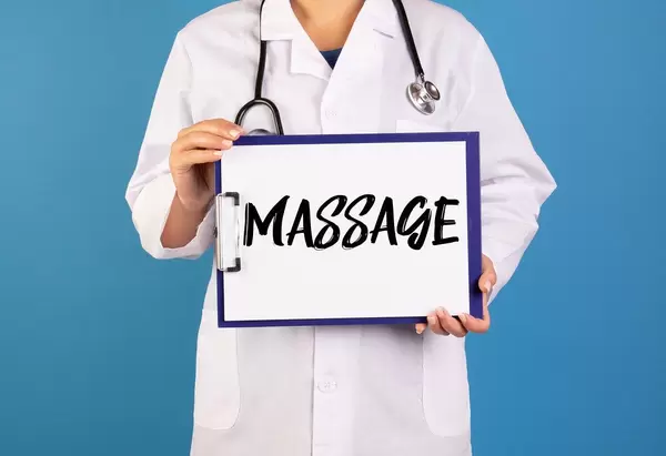 Doctor holding clipboard with Massage text