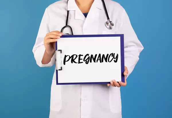 Doctor holding clipboard with Pregnancy text