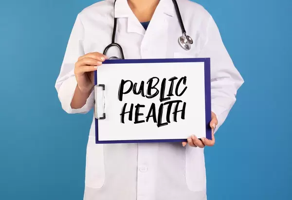Doctor holding clipboard with Public health text
