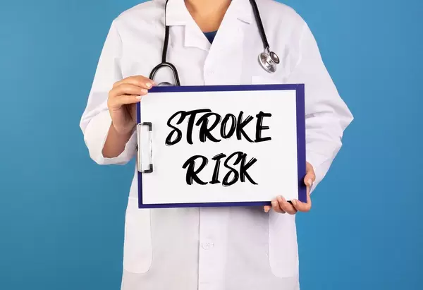 Doctor holding clipboard with Stroke rist text