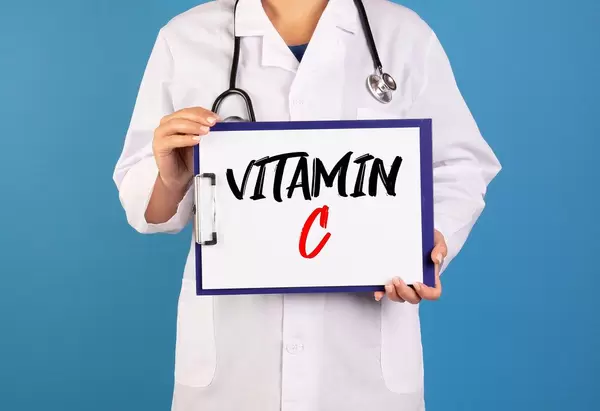 Doctor holding clipboard with Vitamin C text