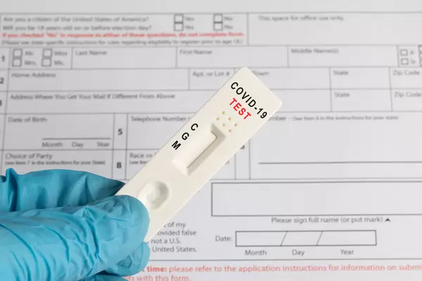 Doctor holding Coronavirus test cassette