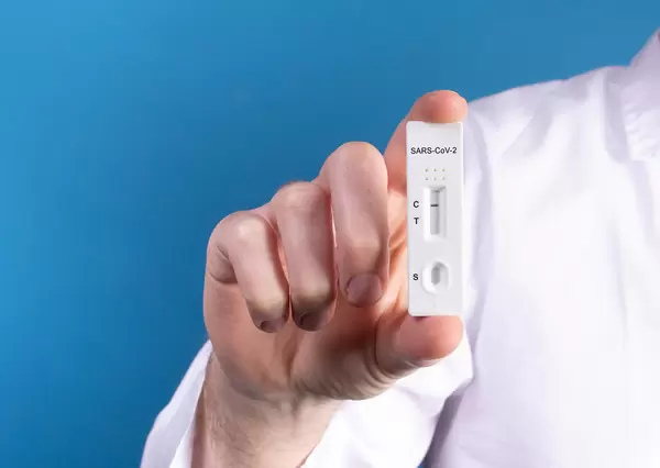 Doctor holding Covid-19 antigen test