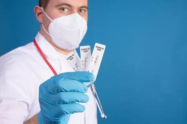 Doctor holding Covid-19 antigen tests