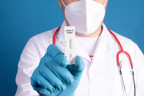 Doctor showing Coronavirus antigen test