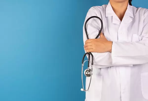 Doctor with a stethoscope on blue background