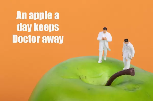 Doctors on apple with An apple a day keeps Doctor away text