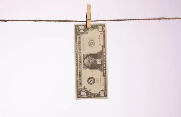 Dollar banknote hanging on a clothes line