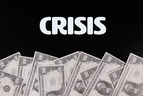 Dollar banknotes with Crisis text on black background