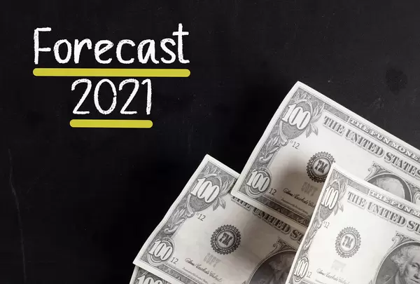 Dollar banknotes with Forecast 2021 text