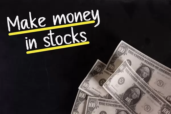 Dollar banknotes with Make money in stocks text