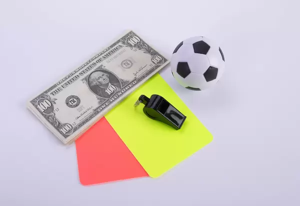 Dollar banknotes with red and yellow referee cards