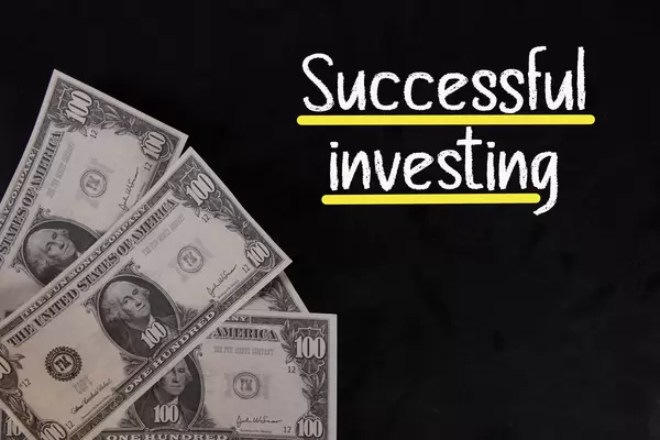 Dollar banknotes with Successful investing text